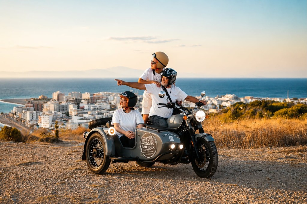 A couple on a vintage sidecar taking in the panoramic view over Rhodes Town