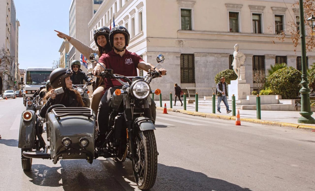 Guests riding in a vintage sidecar through Rhodes streets